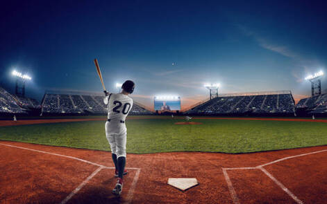 Baseball player at stadium during evening game wearing baseball hats.