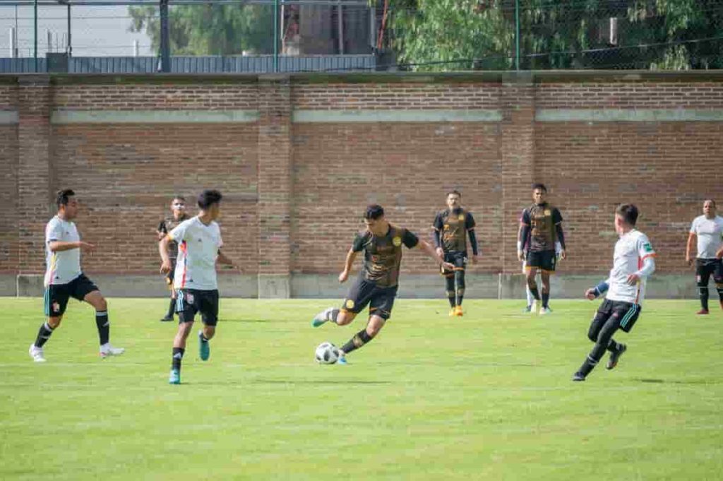 A group of young men playing a game of soccer, focusing on penalties in football.