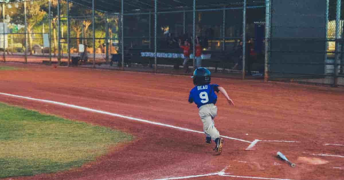 A child running on a baseball field, embodying the joy of youth and the future of baseball pension.