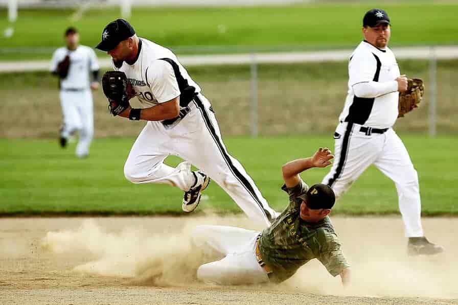 MLB old teams: A baseball player sliding into a base during a game on a field, capturing the historical essence of Major League Baseball's oldest franchises.