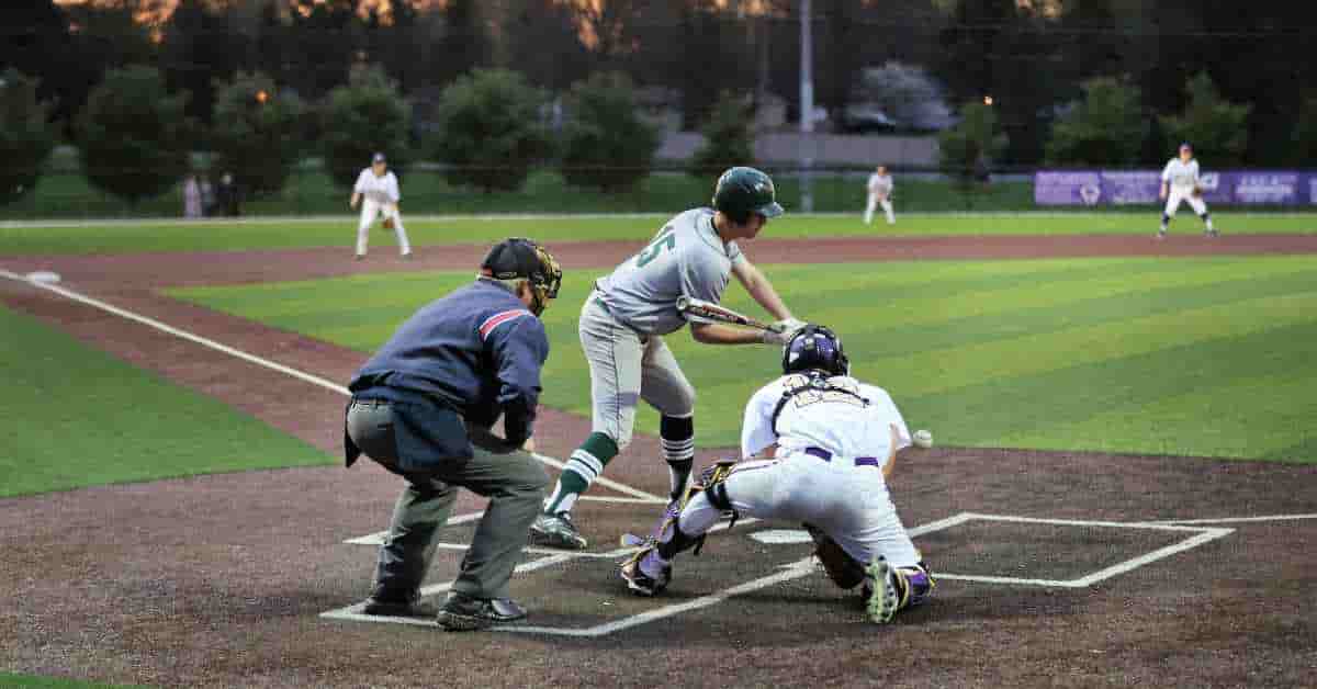 Baseball players on a field during a game, illustrating different positions and roles from MLB to Little League - How Many Players Are On A Baseball Team