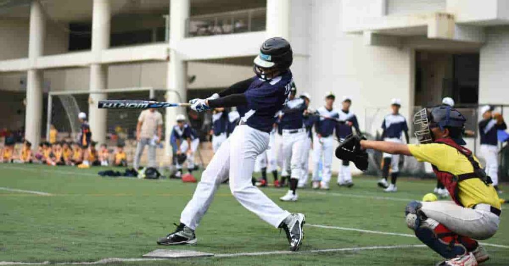 A baseball player swinging a bat at a ball during pool play in baseball.