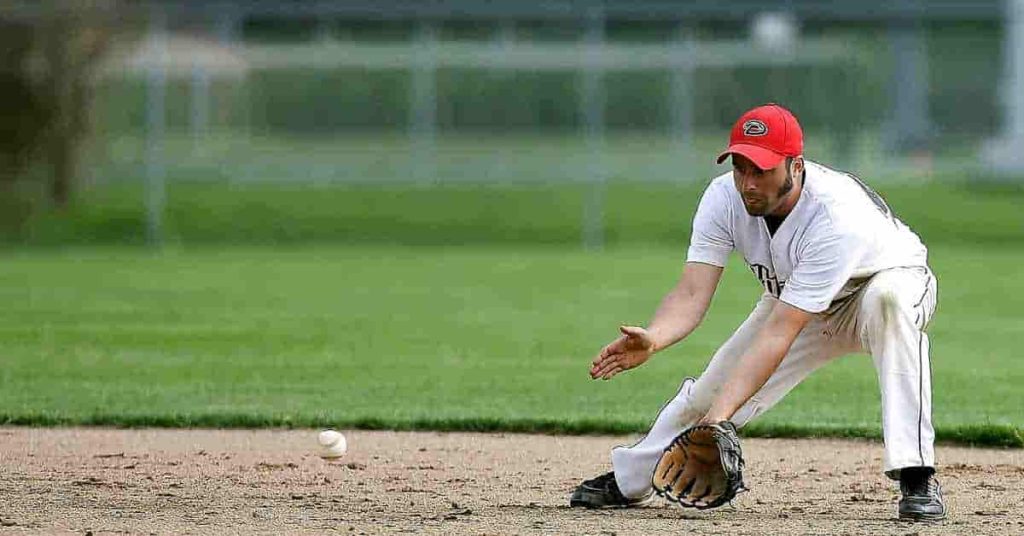 A baseball player catching a ball on a field during pool play in baseball.