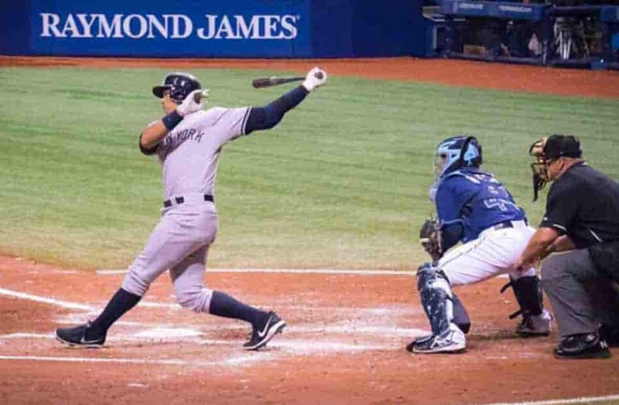 A baseball player swinging a bat on a field, part of a pool play in baseball.