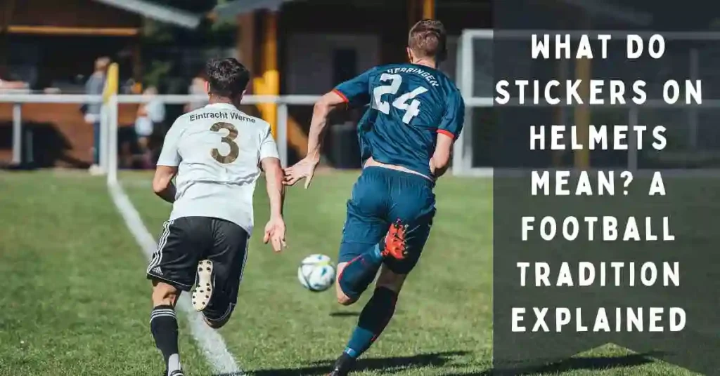 A couple of football players wearing helmet stickers kicking a ball around a field.