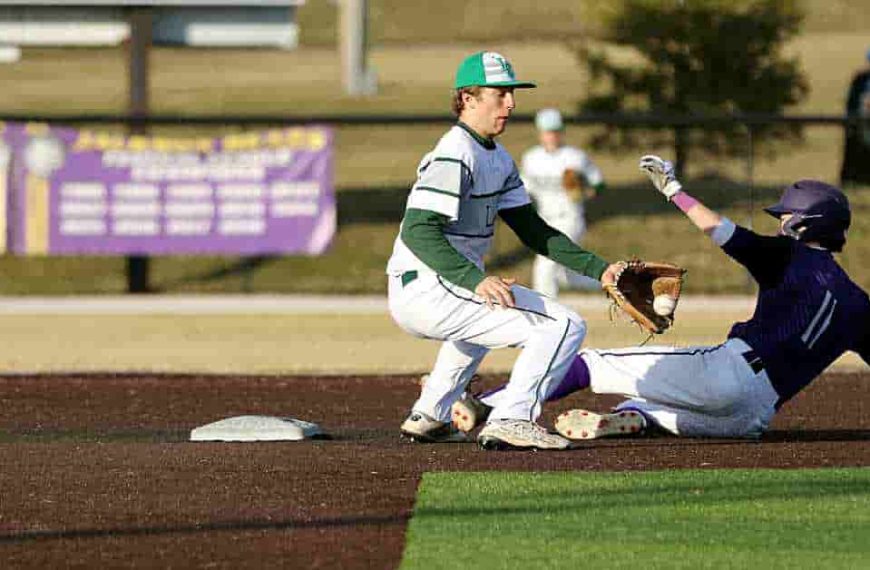 Baseball player sliding into a base during a game, illustrating a key moment of gameplay before a potential designate for assignment in baseball.