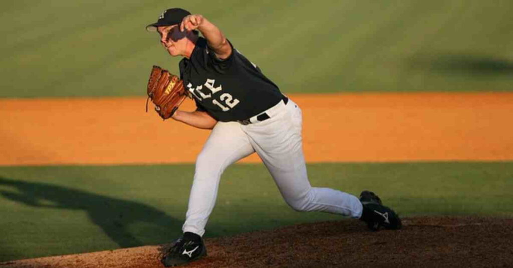 A baseball player pitching a ball on a field, illustrating the question of how do MLB players get paid.