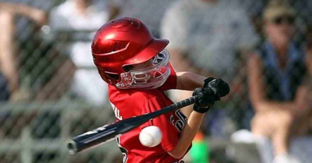 A baseball player swinging a bat at a ball, relating to the topic of how do MLB players get paid.