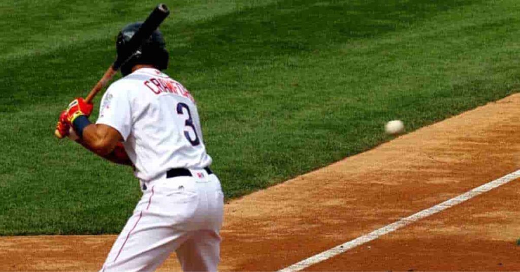 Best baseball radar guns capturing a baseball player in a white jersey with 'Cordero' and number 3 preparing to hit as a pitch approaches on a grassy field.