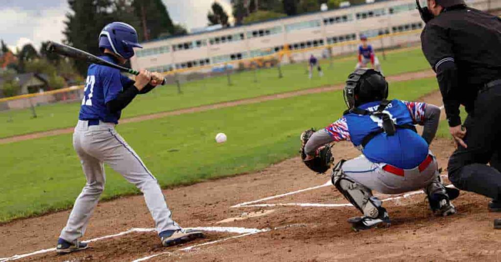 Baseball player swinging a bat at a ball, capturing the action before a potential designate for assignment in baseball.