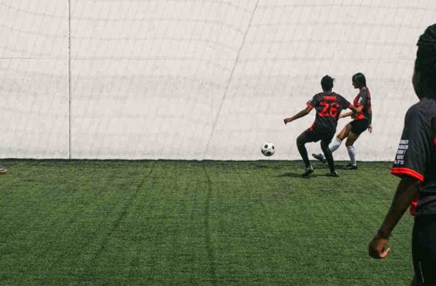 A group of people playing a game of soccer, showcasing how football cleats fit during the match