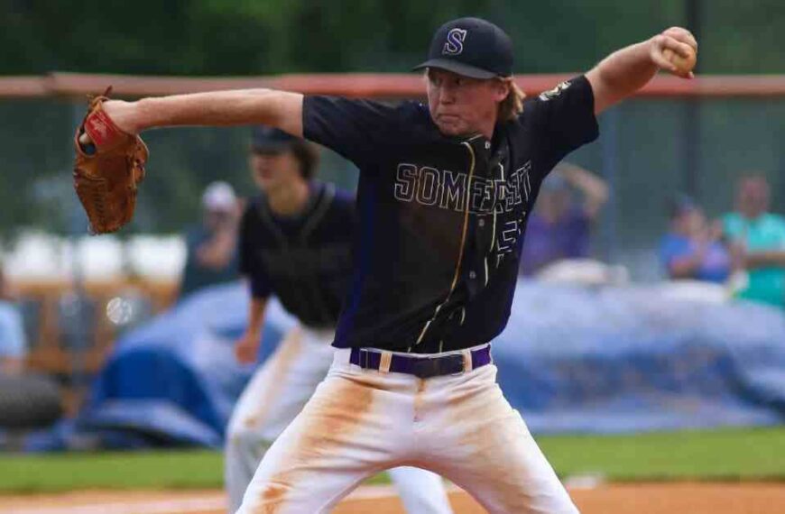 A baseball player pitching a ball on top of a field, illustrating the intensity of the 'war in baseball.