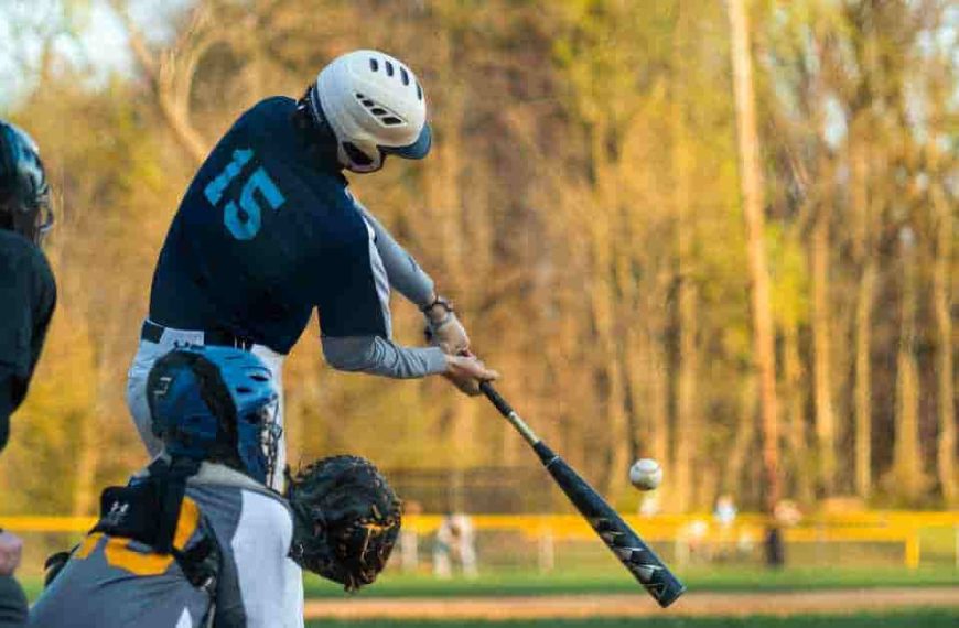 A baseball player swinging a bat at a ball, showcasing the whip in baseball technique.