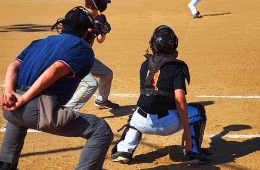 A group of young men playing a game of baseball, representing the topic of how do MLB players get paid.