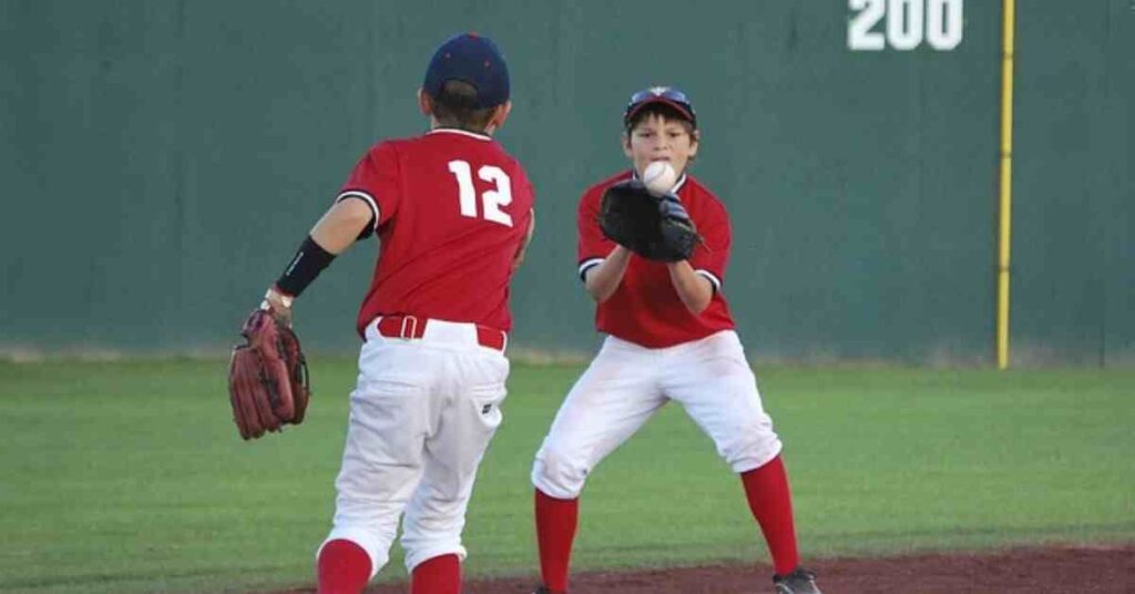 Rafael Devers and another young man standing on a baseball field.