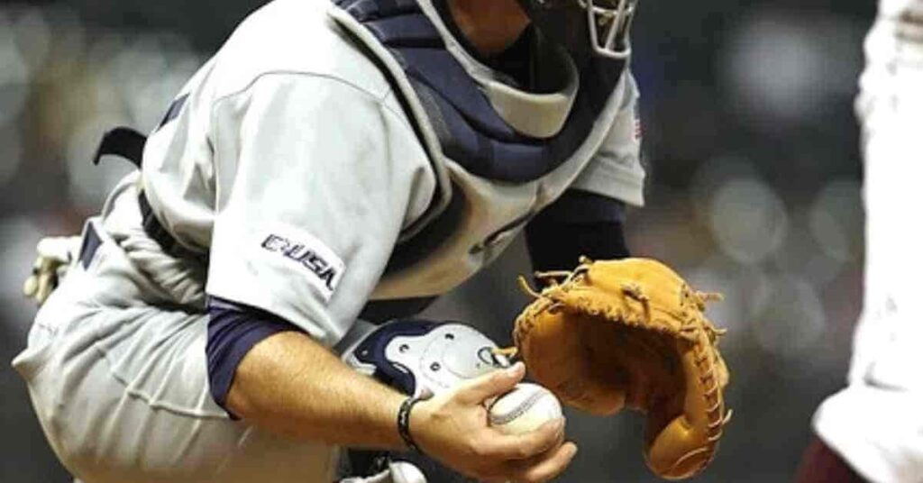 A Nationals top prospect baseball player holding a catcher's mitt on the field.