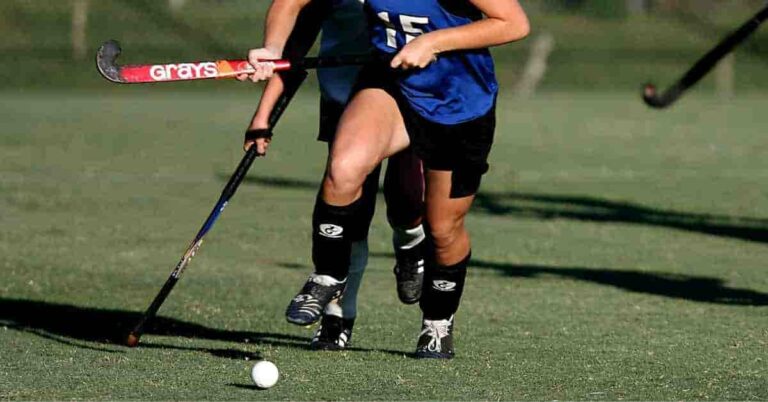 Marcus Semien’s contract value represented metaphorically by a girl in a blue uniform playing field hockey.