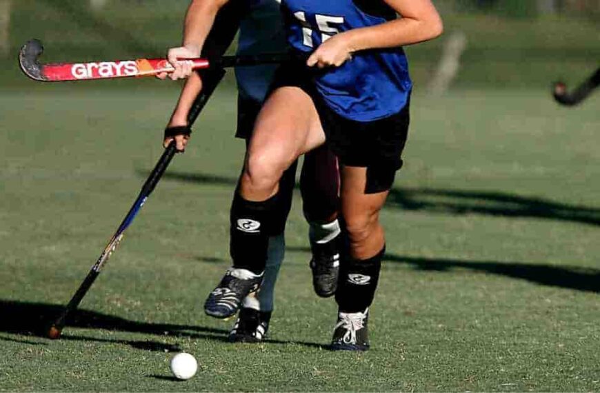 Marcus Semien’s contract value represented metaphorically by a girl in a blue uniform playing field hockey.