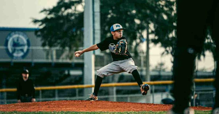 Paul Goldschmidt pitching a baseball on a field.