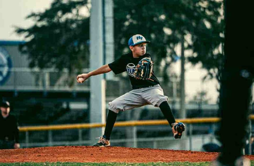 Paul Goldschmidt pitching a baseball on a field.