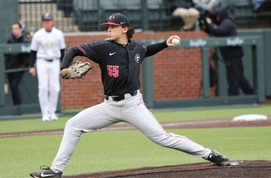 Matt Olson, a baseball player, pitching a ball on top of a field.