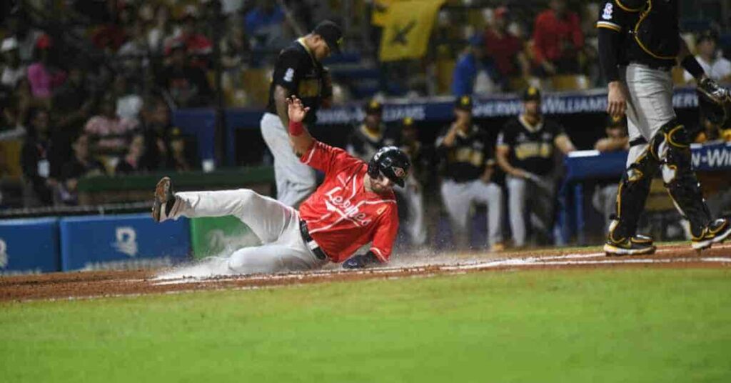 Yariel Rodriguez, a baseball player, sliding into a base during a game.