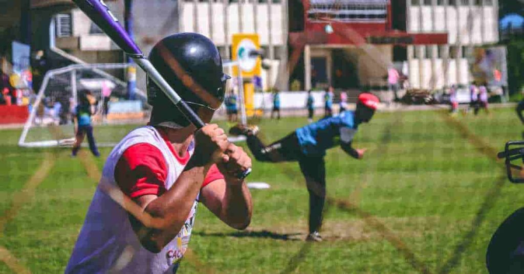 A baseball player, resembling Orelvis Martinez, holding a bat on a field, showcasing his potential in the sport.