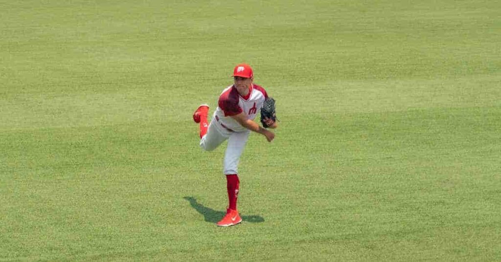 Seth Lugo in a red and white uniform pitching a baseball.