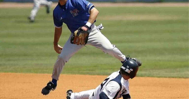 A Nationals top prospect baseball player sliding into a base during a game.