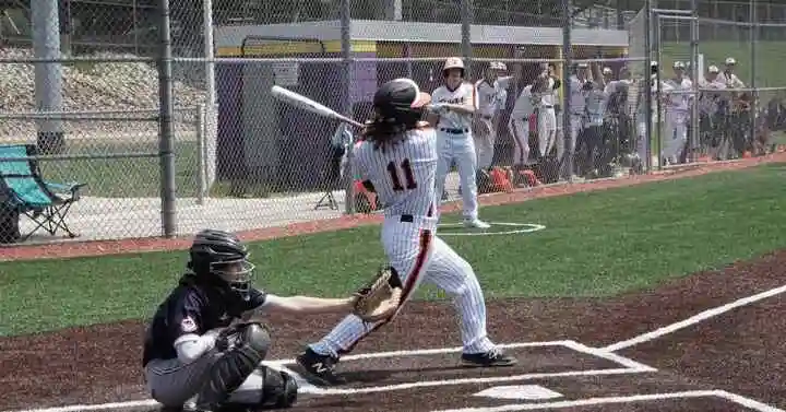 A baseball player swinging a bat at a ball, with a focus on the question balk in baseball.