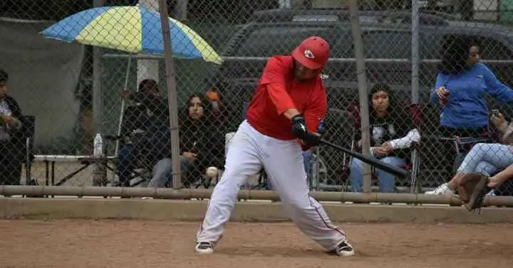 A baseball player swinging a bat at a ball, with a question about balk in baseball .