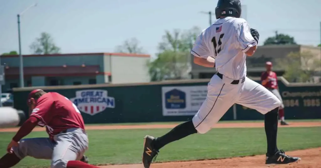 A baseball player running to first base during a game, demonstrating a key baseball term.