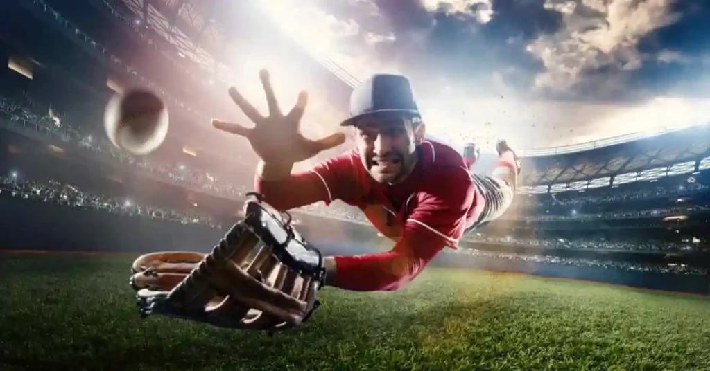 a baseball player diving for a ball in a stadium, featuring one of the oldest players in action