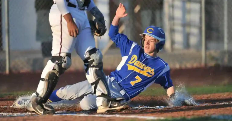 A baseball player sliding into home plate during a game, showcasing a key baseball term in action.